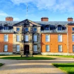 What is the geographical and administrative setting of Dunham Massey