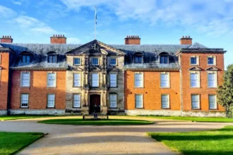 What is the geographical and administrative setting of Dunham Massey