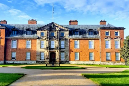 What is the geographical and administrative setting of Dunham Massey