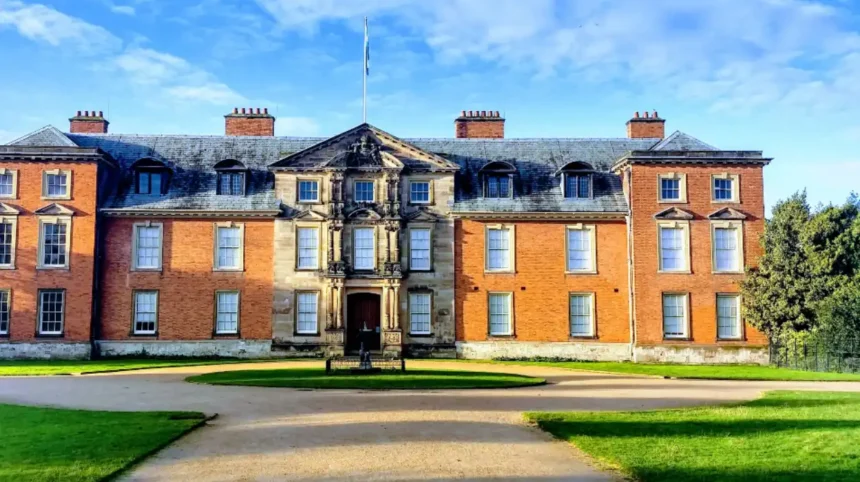 What is the geographical and administrative setting of Dunham Massey