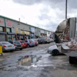 Bury New Road fire destroys the Marc Darcy showroom in Salford as crews tackle hotspots, roads remain closed and police investigate the scene.