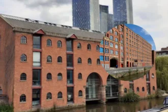 Ancoats Canal dog rescue strangers lower man over water edge